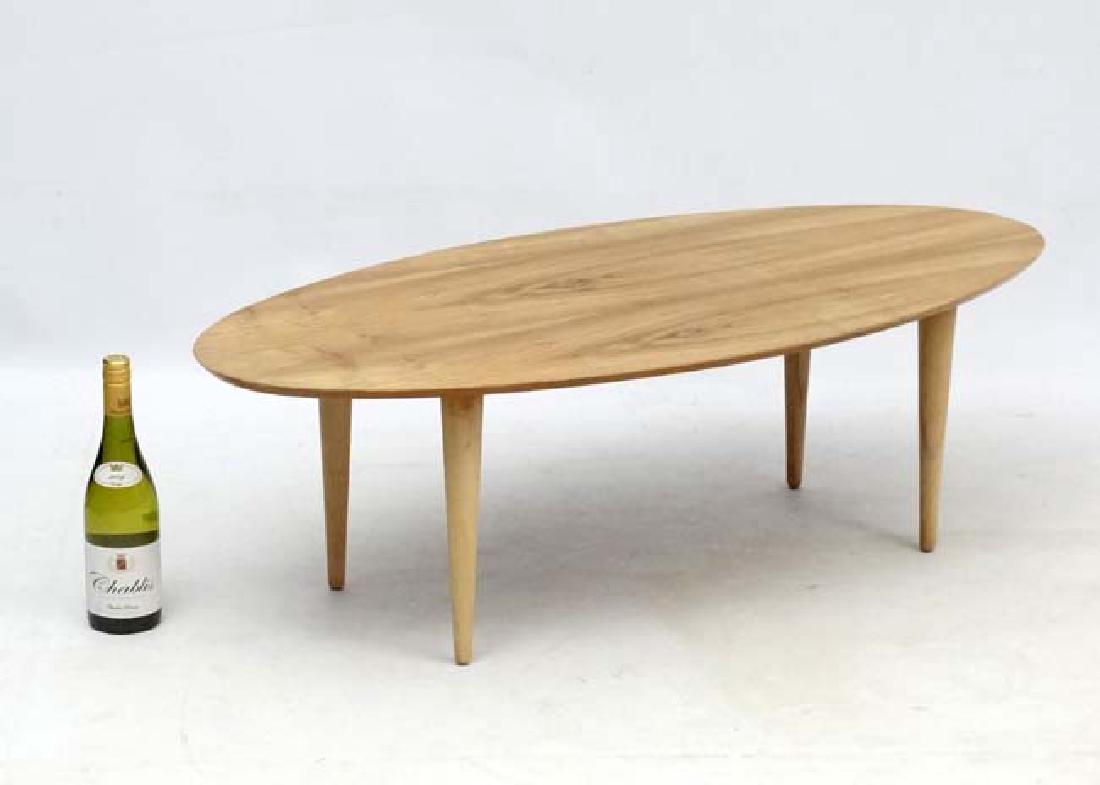 Vintage Retro : an Afrormosia oval shaped coffee table: Vintage Retro : an Afrormosia oval shaped coffee table with turned tapering beech legs , measuring 19 3/4'' wide x 42'' lx 13'' high.