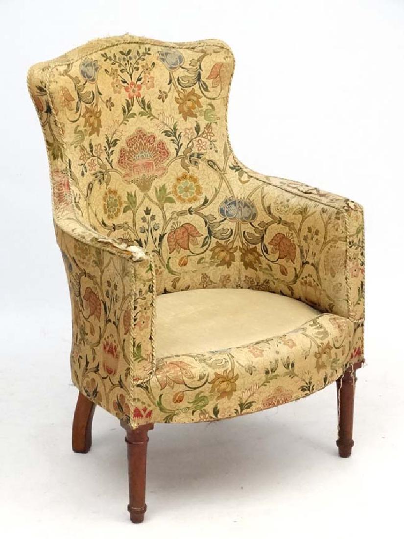 A late Victorian shaped back armchair with walnut show: A late Victorian shaped back armchair with walnut show wood 36 1/2'' high