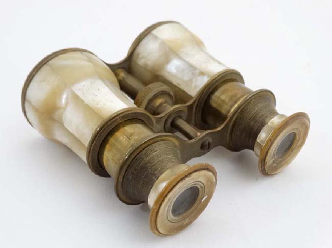 A pair of 19thC mother of pearl and brass theatre /: A pair of 19thC mother of pearl and brass theatre / opera glasses. Approx 4 1/2'' wide