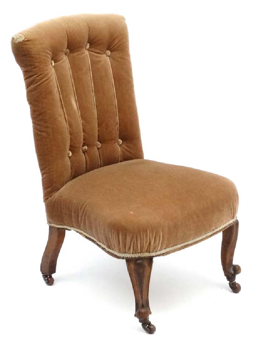 A Victorian walnut nursing chair with overstuffed (1 of 4)