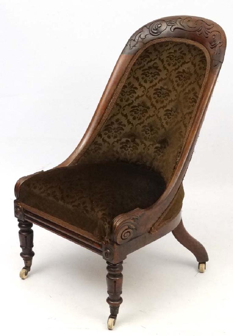 A William IV rosewood slipper chair with overstuffed: A William IV rosewood slipper chair with overstuffed seat and carved decoration 36 1/2'' high