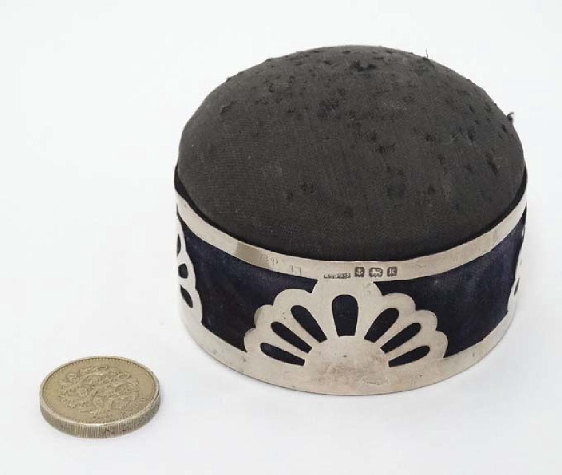 A pin cushion / hat pin holder of circular domed form: A pin cushion / hat pin holder of circular domed form with hinged lid and silver mounts hallmarked Birmingham 1909 maker King & Sons. 2 3/4'' diameter