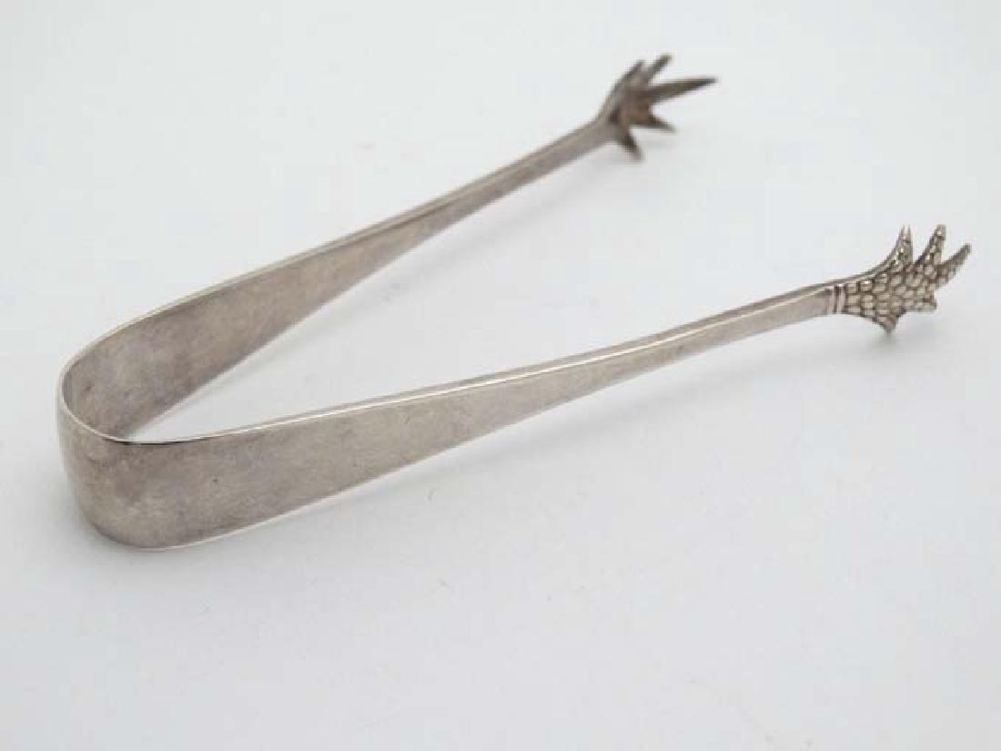 Silver sugar tongs with birds claw grips hallmarked: Silver sugar tongs with birds claw grips hallmarked Sheffield 1921 maker John Thompson & Sons. 3 1/2'' ong (14g)
