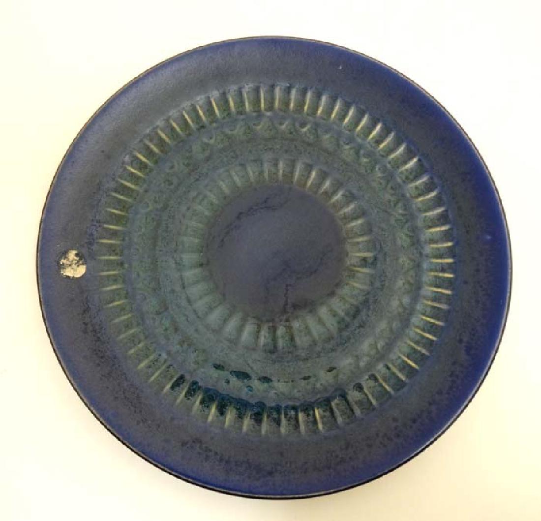 Scandinavian Pottery: A 1960s/70s Mari Simmulson for: Scandinavian Pottery: A 1960s/70s Mari Simmulson for Upsala Ekeby , Sweden pottery dish decorated in shades of blue and green with ridged detail, bears factory stamp to base. 8'' diameter.