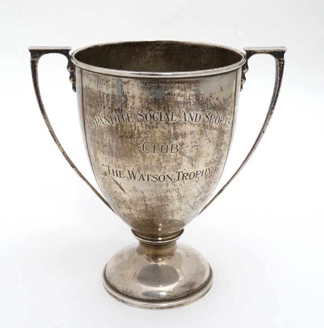 A silver trophy cup with two handles and engraved ' (1 of 4)