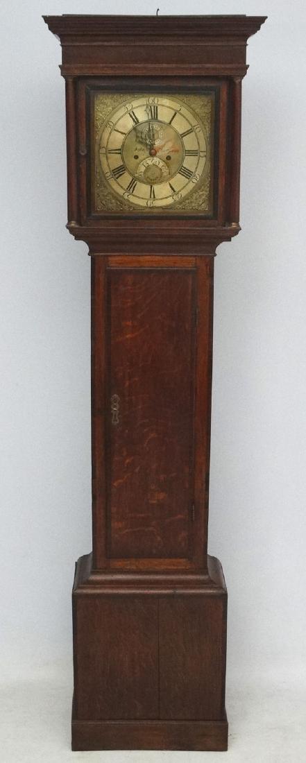 Longcase : ' John Thompson , London ' a late 18 th C: Longcase : ' John Thompson , London ' a late 18 th C Oak cased and cross banded Grandfather clock with a 12'' brass square dial , seconds dial at 12 and date ring at 6, with columns to the hood , long