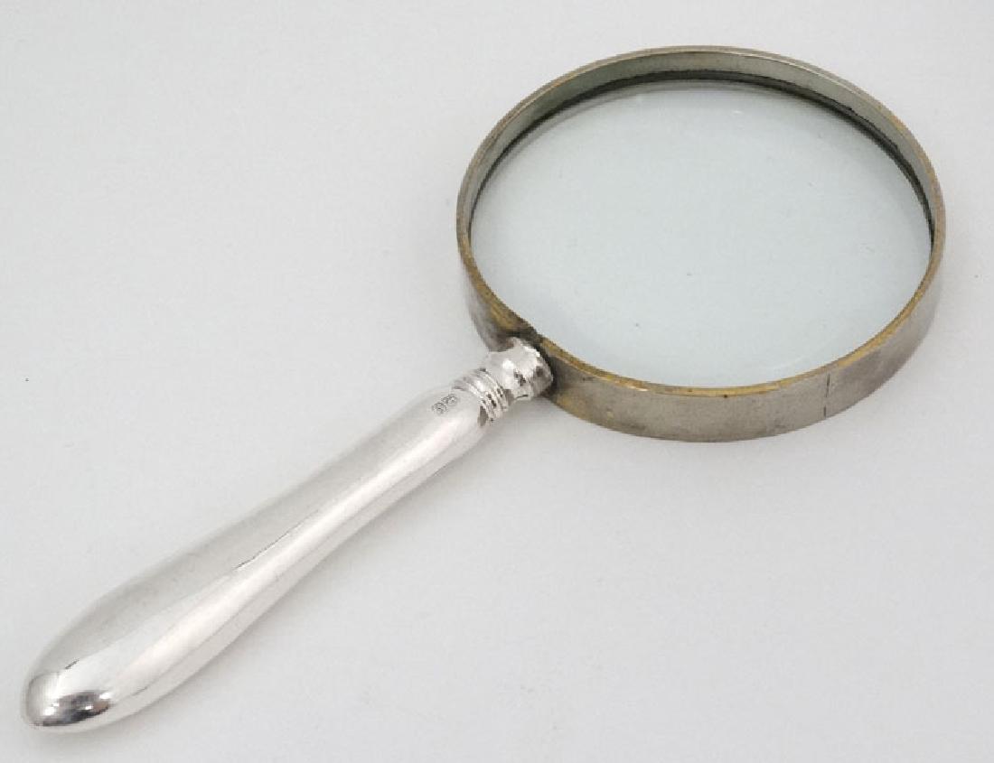 A silver handle magnifying glass 6'' long overall: A silver handle magnifying glass 6'' long overall