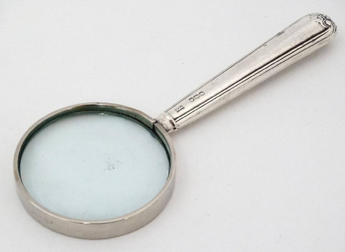 A silver handled magnifying glass 5 1/4'' long overall (1 of 4)