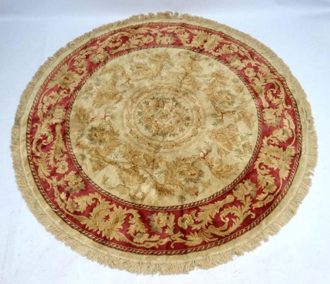 Rug & Carpet : a Aubusson style woollen circular: Rug & Carpet : a Aubusson style woollen circular carpet having red, buff and red and a few black, colours, 87 '' diameter.