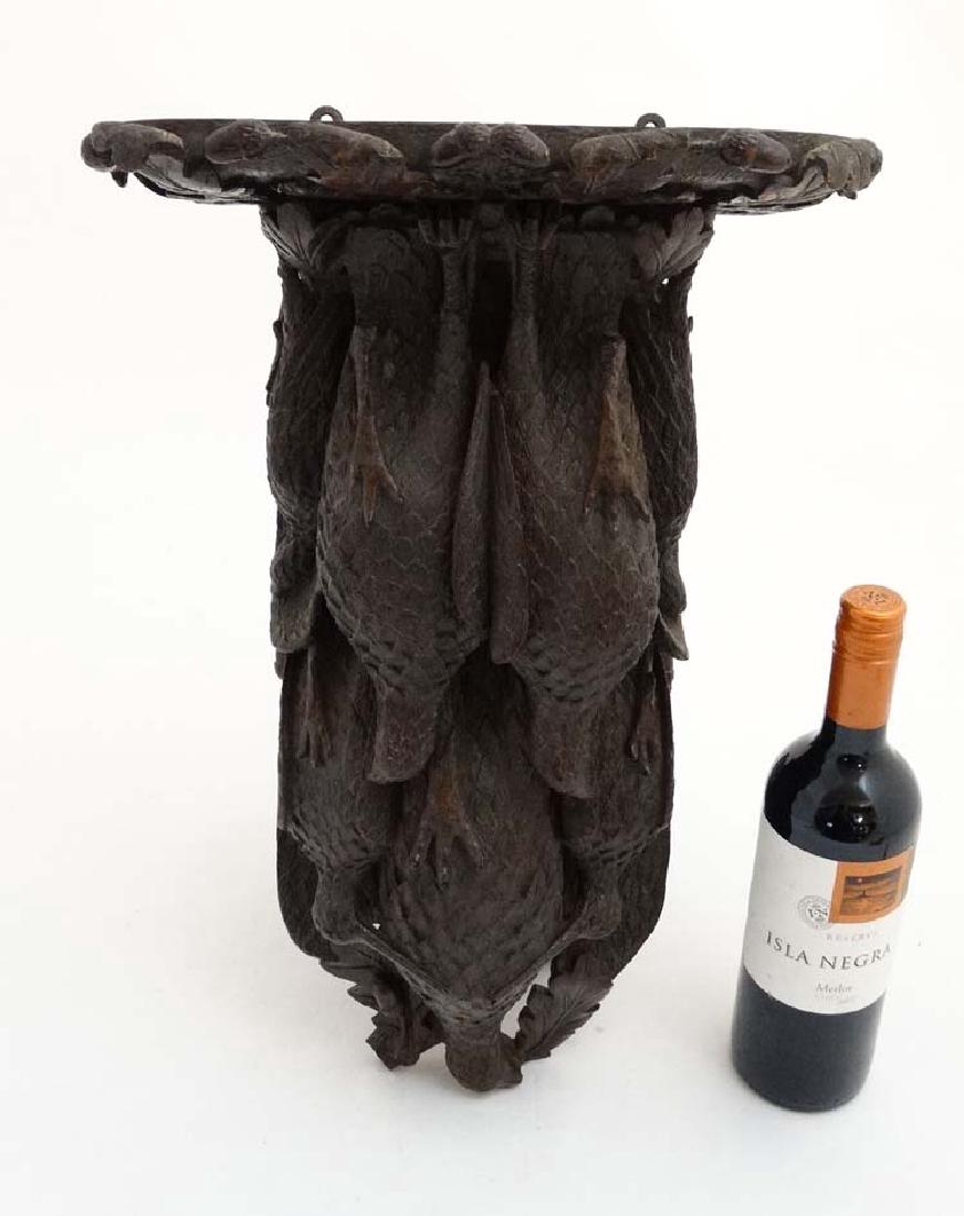 Black Forest : a 19 th C well carved wooden clock: Black Forest : a 19 th C well carved wooden clock bracket in the form of various game birds , including partridge , snipe etc. in an oak surround , marked to back ' P Cairns ' ( carver?) , 19'' high x