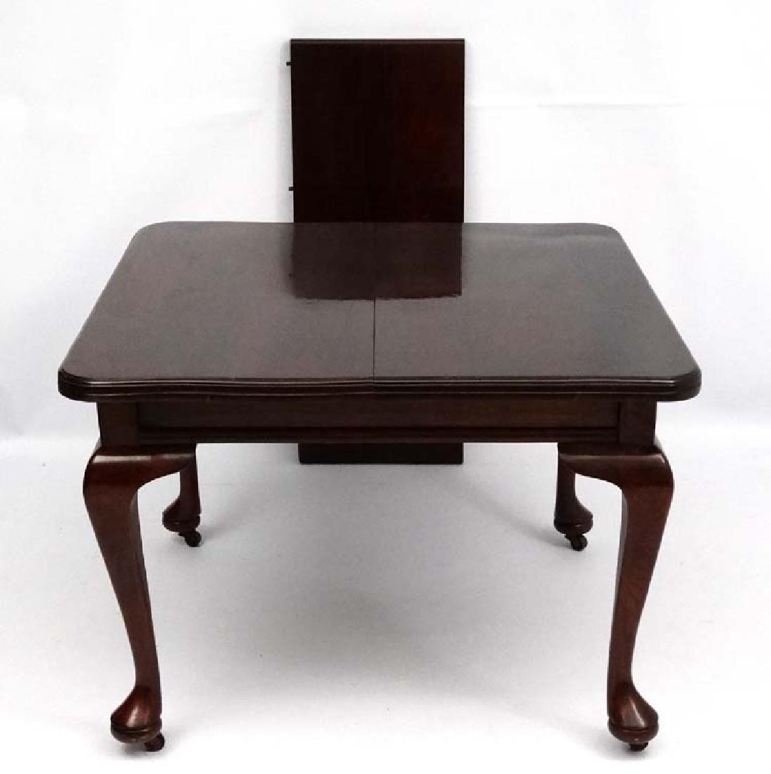 An early 20thC Queen Anne style stained pine dining: An early 20thC Queen Anne style stained pine dining table with single leaf. 40 1/2'' wide x 40 1/2'' long x 29 1/2'' the leaf measuring 16 1/2'' wide.