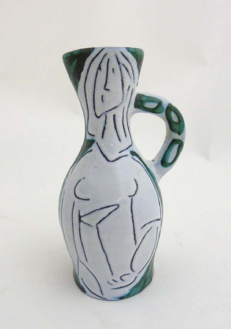 A 1950s French pitcher in the manner of Jacques: A 1950s French pitcher in the manner of Jacques Innocenti, decorated with stylised abstract female figure (influenced by Pablo Picasso), in typical matt black on a white crackle glazed ground with gre