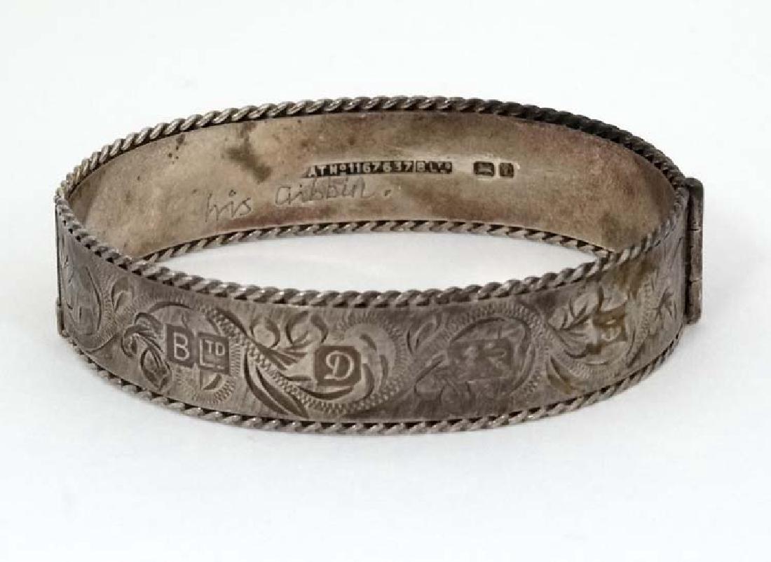 A silver bangle with engraved decoration. Hallmarked (1 of 6)