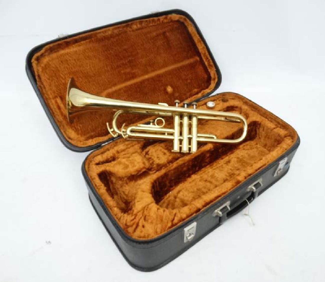 Musical Instruments : A 20thC Cornet , the horn stamped: Musical Instruments : A 20thC Cornet , the horn stamped ' Cor Ton . ' In maker's case with mouthpiece . 21'' long
