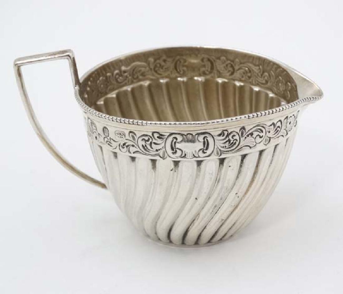 A Victorian silver cream jug with fluted and embossed (1 of 5)