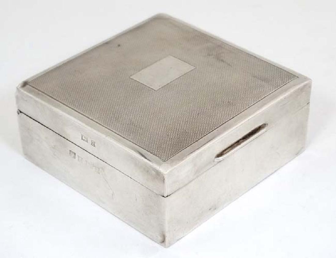 A silver desk top cigarette box with hinged lid and (1 of 4)