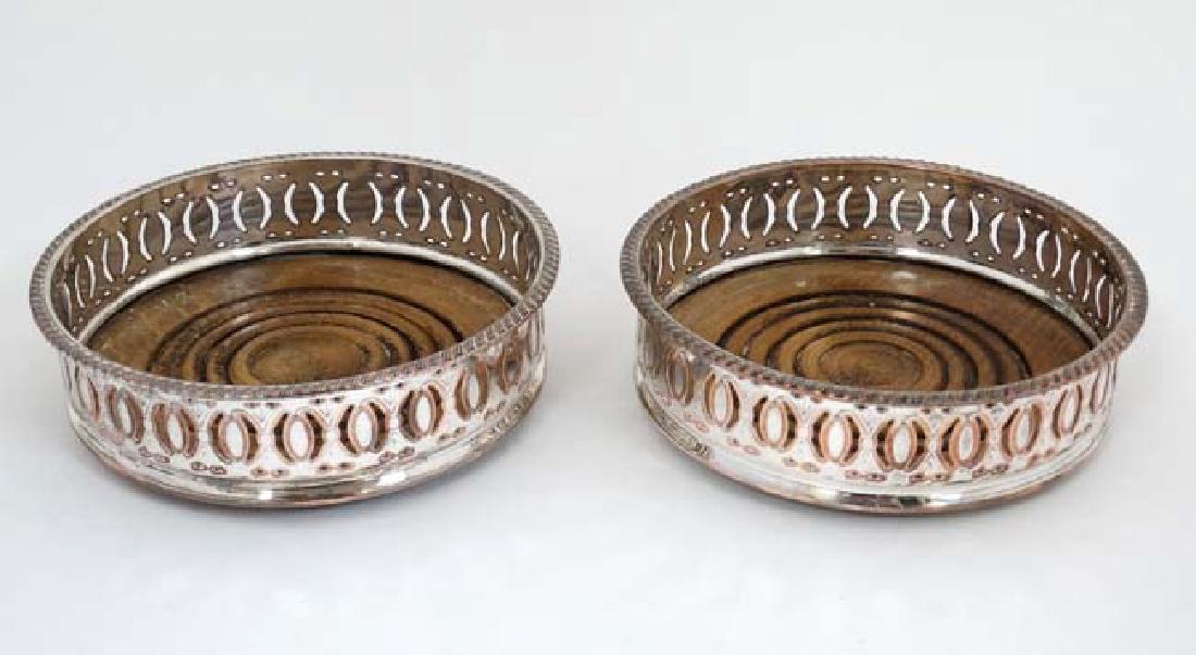 A pair of Sheffield plate bottle coasters with turned (1 of 4)