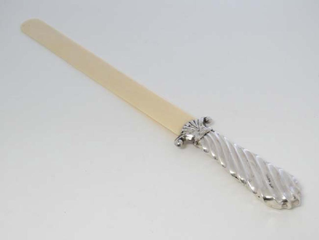 A Victorian  ivory page turner with silver handle (1 of 4)