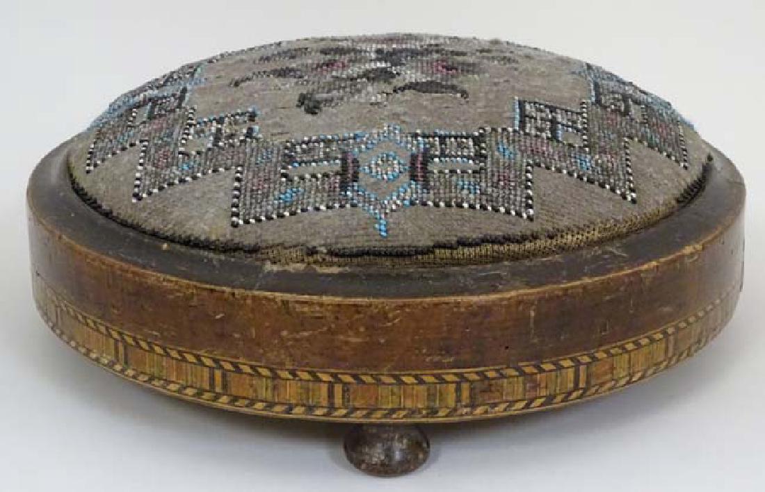 A Victorian circular 3-footed beadwork footstool with: A Victorian circular 3-footed beadwork footstool with inlaid banded decoration approx 11'' diameter