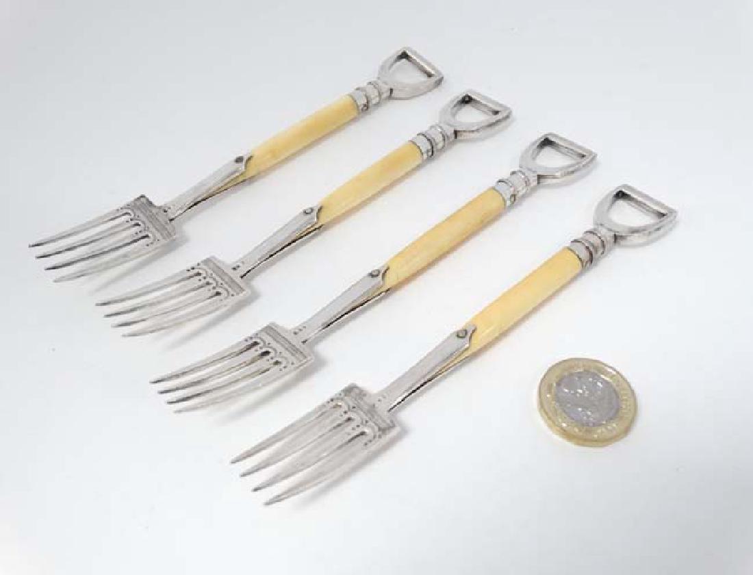 A set of 4 early 20thC silver plate novelty forks: A set of 4 early 20thC silver plate novelty forks formed as garden forks with loop handles. Each approx. Approx 5 12'' long