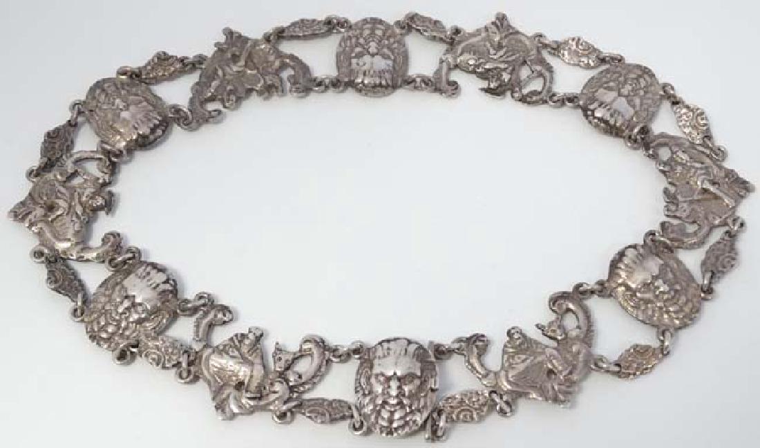 An unusual white metal choker / necklace with mythical: An unusual white metal choker / necklace with mythical male mask and figural decoration. approx 15'' long