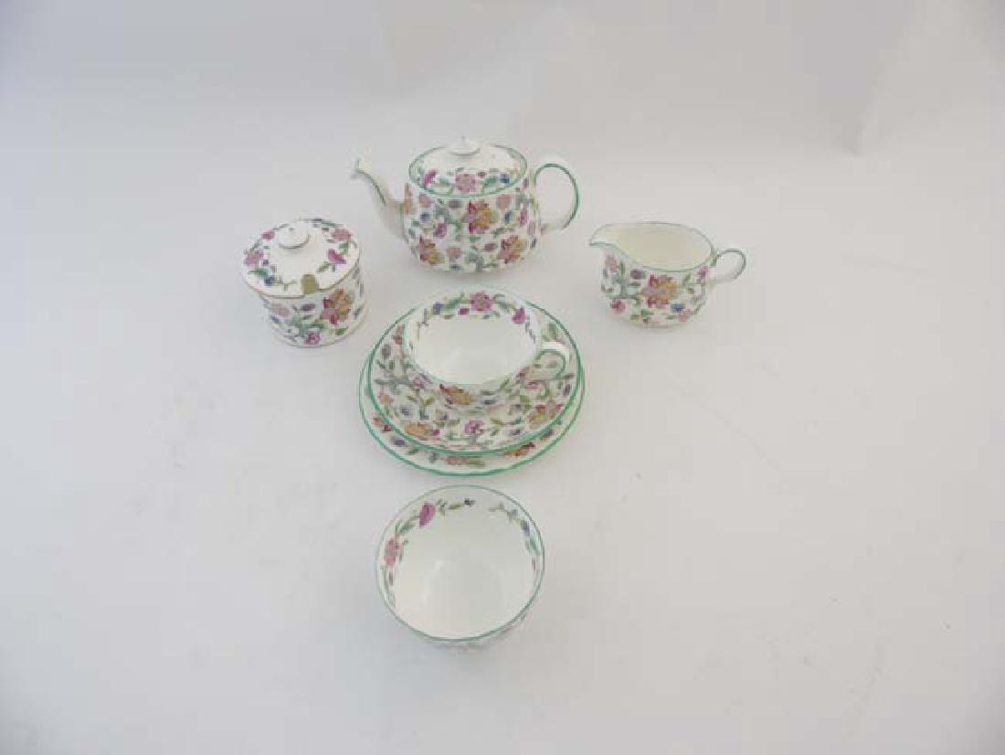 A Minton bone china 'Haddon hall' bachelor tea set: A Minton bone china 'Haddon hall' bachelor tea set designed by John Wadsworth, including a teapot, 2 sugar bowls, teacup and saucer and milk jug, all decorated with pink, blue, yellow coloured flowers