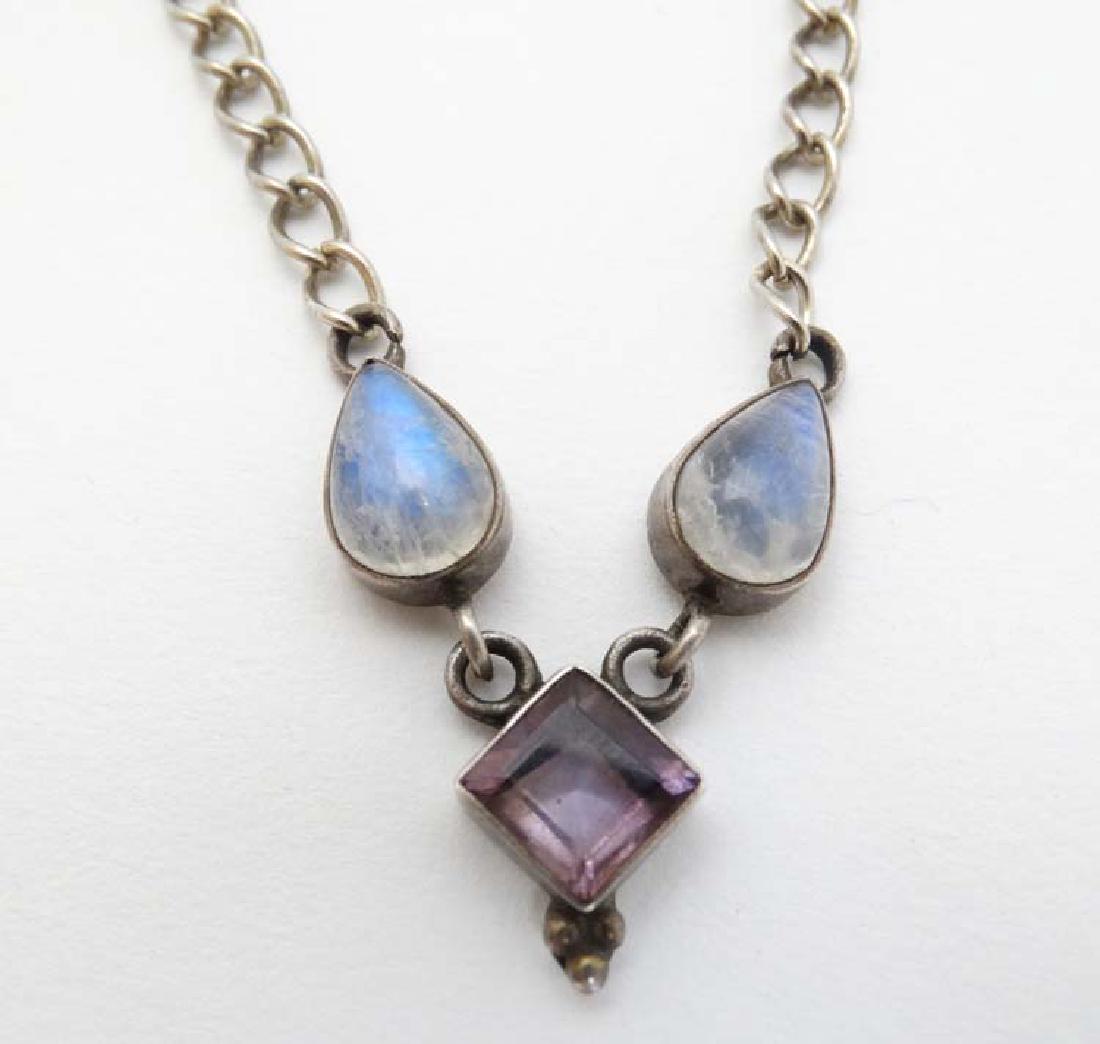 A silver necklace set with moonstone and amethyst: A silver necklace set with moonstone and amethyst detail. approx 16'' long