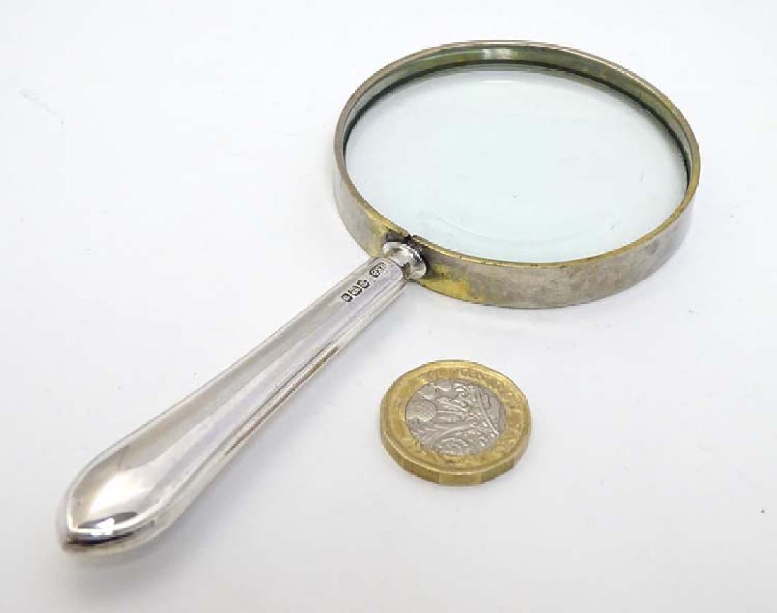 A magnifying glass with silver handle 5 1/2'' long: A magnifying glass with silver handle 5 1/2'' long