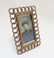 An Edwardian copper photograph frame with curved chain