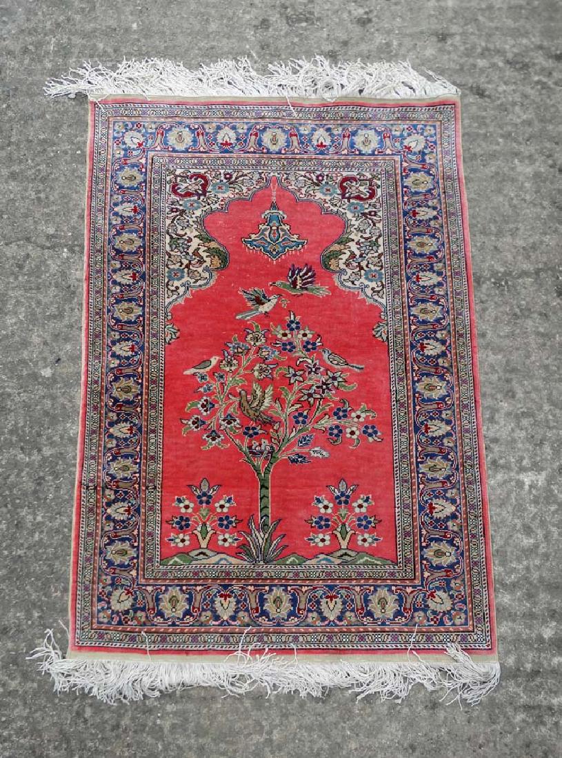 Rug / Carpet : a hand made silk Islamic prayer rug ,: Rug / Carpet : a hand made silk Islamic prayer rug , with red central ground having doorway shape , birds amongst a tree , having an external border having ,red , beige , brown and blue etc. colours, 