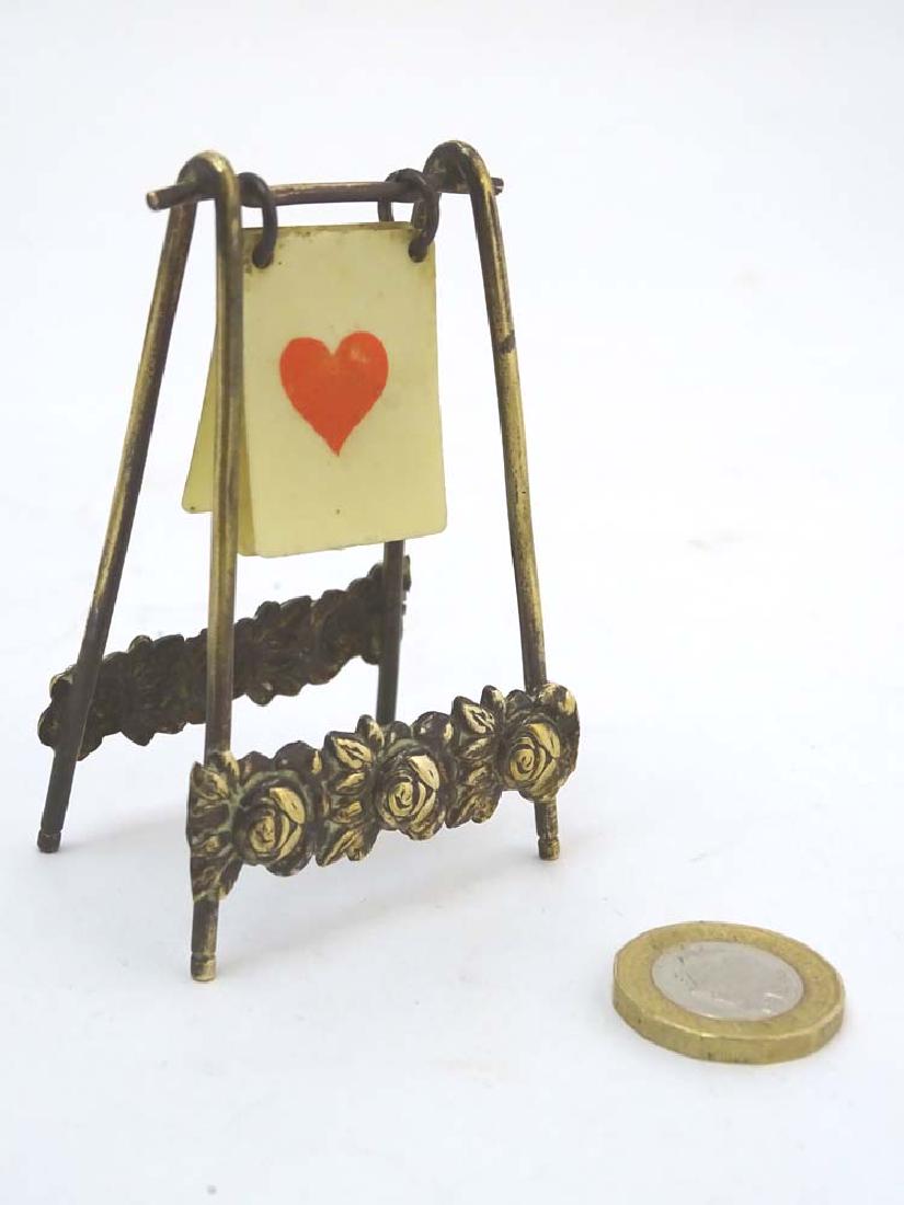 A brass playing card trump marker, 3'' high: A brass playing card trump marker, 3'' high