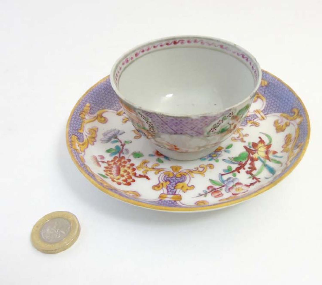 A matched tea cup and saucer comprising a 19thC Minton: A matched tea cup and saucer comprising a 19thC Minton purple Sarreguemines oriental saucer together with an oriental / Chinese tea cup / bowl depicting figures in a domestic and outdoor scene, saucer