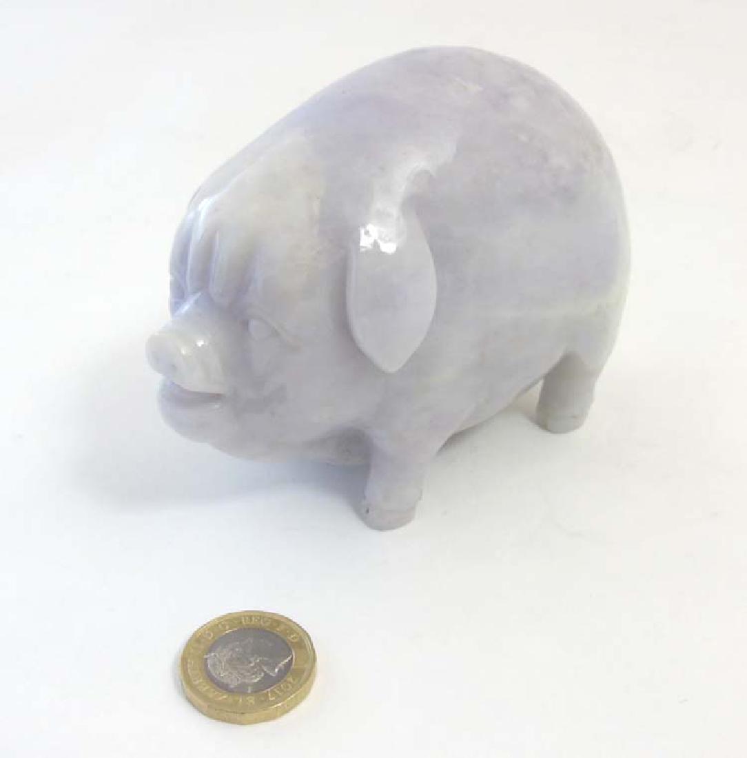 A Chinese pink / lavender coloured jade model of a: A Chinese pink / lavender coloured jade model of a pot bellied pig 4 1/8'' long x 3'' high