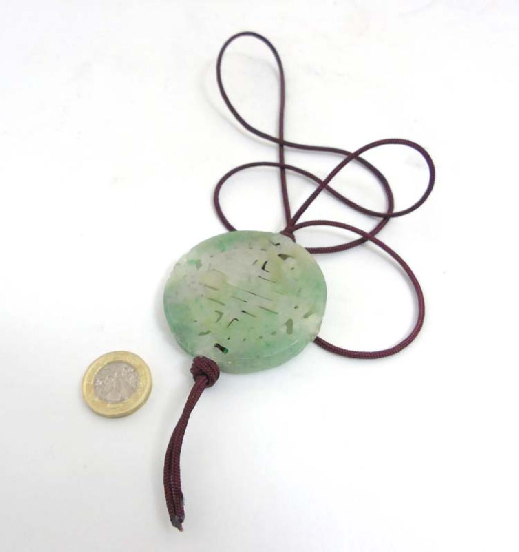 A Chinese pendant of green flecked jadeite / nephrite, (1 of 8)