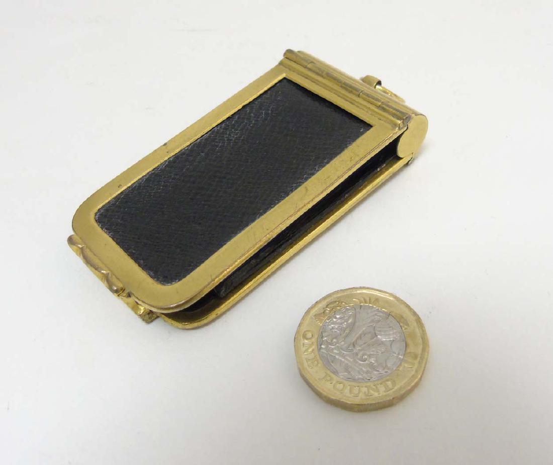 A gold plated dance card holder with sprung hinge and: A gold plated dance card holder with sprung hinge and blue watered silk lining with pockets and pencil holder within 3'' x 1 1/2''