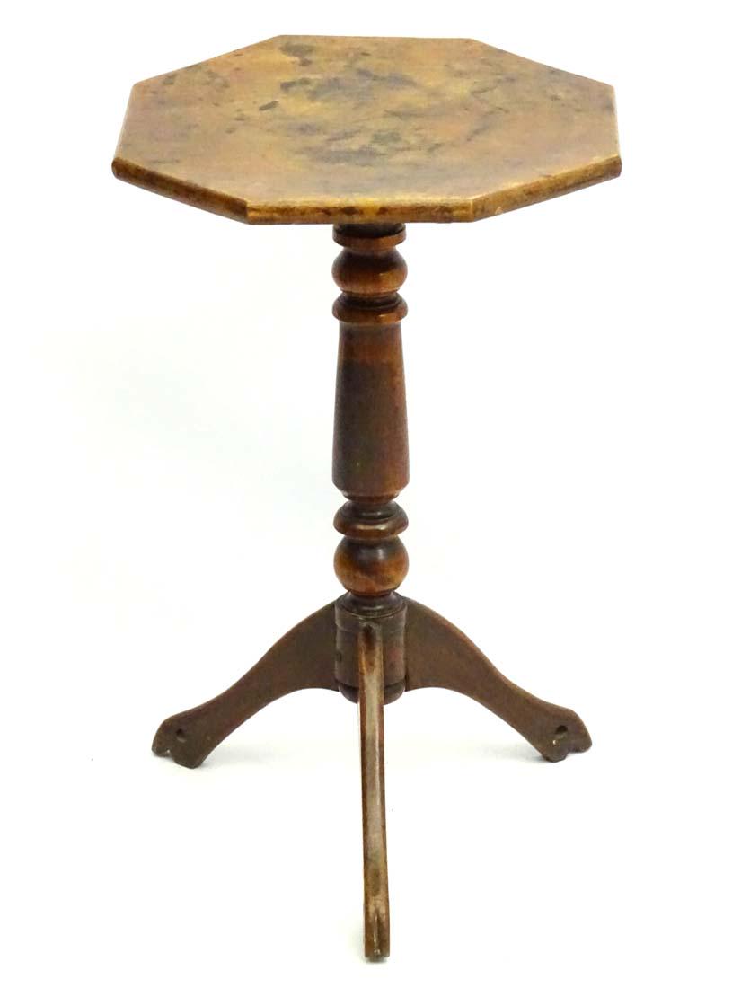 An early / mid 19thC fruitwood tripod table with: An early / mid 19thC fruitwood tripod table with octagonal top, standing on unusual pierced legs. 17'' wide x 16 Â¾'' deep x 29'' high