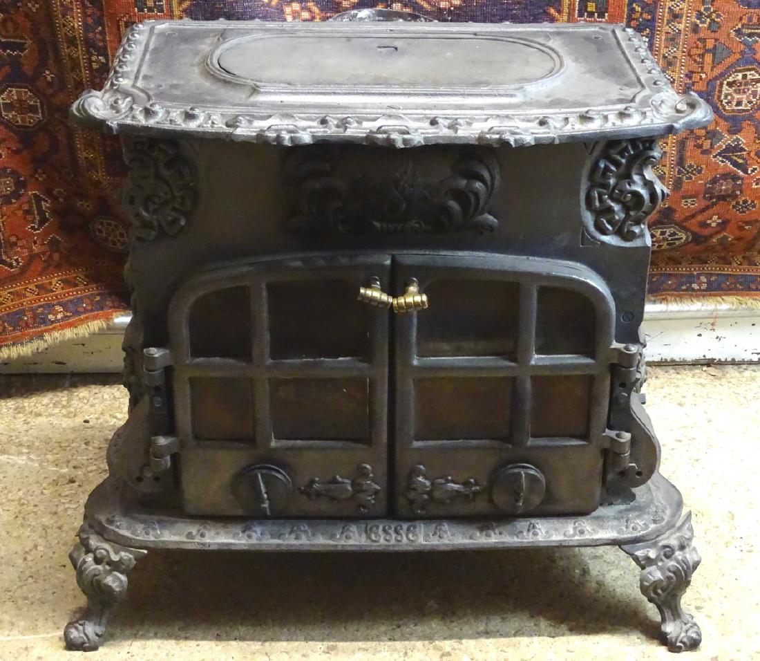 Wood burner : an ornate cast iron Esse 2 door wood: Wood burner : an ornate cast iron Esse 2 door wood burner , measuring 27'' wide x 26'' high .
