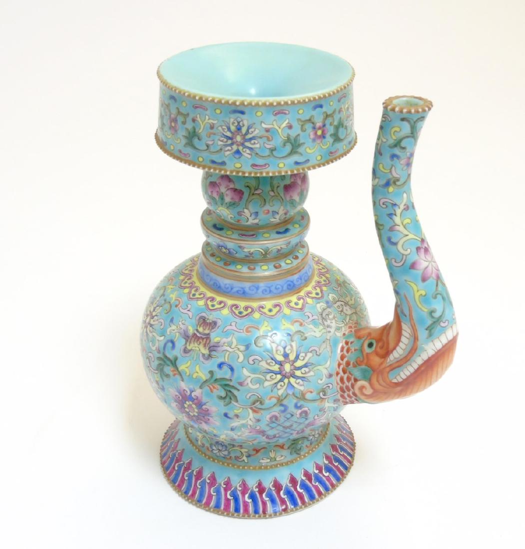 A Chinese Famille Rose turquoise-ground: A Chinese Famille Rose turquoise-ground cloisonnÃ©-imitation ceremonial wine ewer and lid, decorated with the eight Buddhist emblems amidst scrolling lotus, having a red dragons head to base of spou