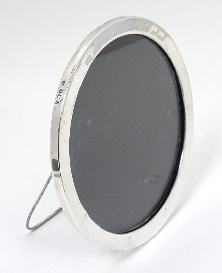 A silver photograph frame of circular form hallmarked (1 of 5)