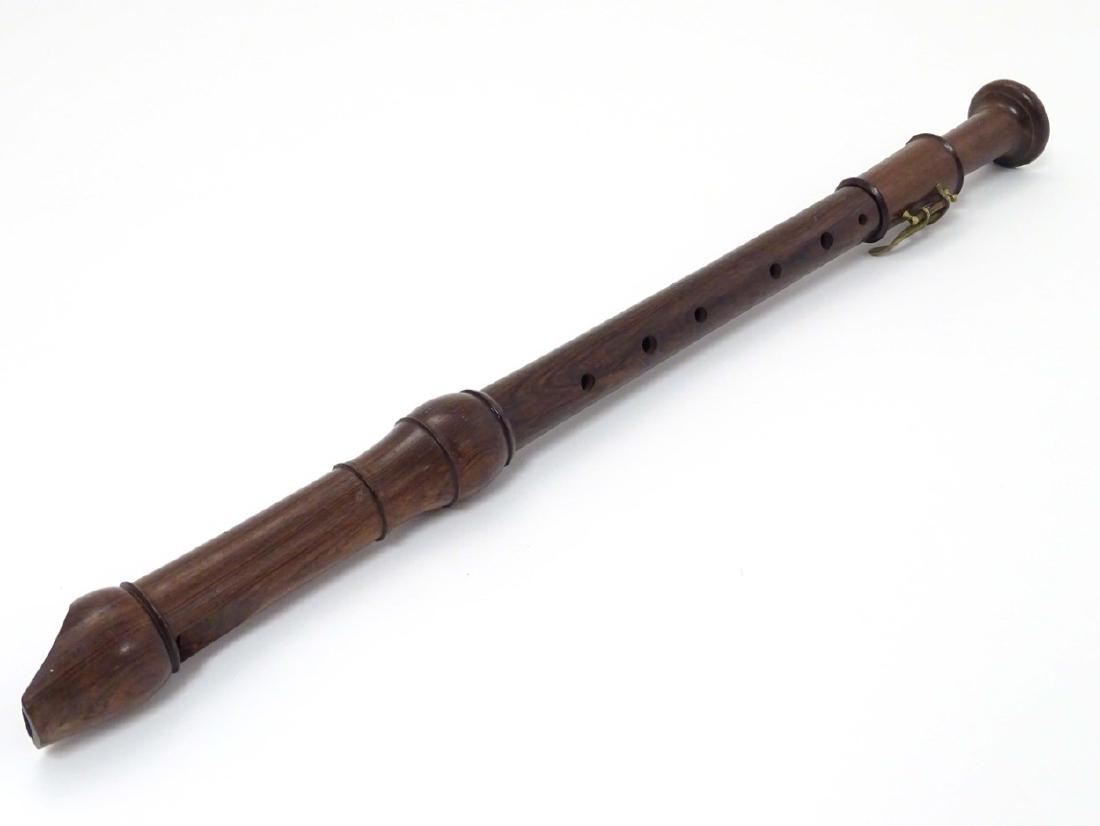 Musical Instruments: A Victorian tenor recorder flute,: Musical Instruments: A Victorian tenor recorder flute, of rosewood construction in three sections, with single brass key. 24'' long