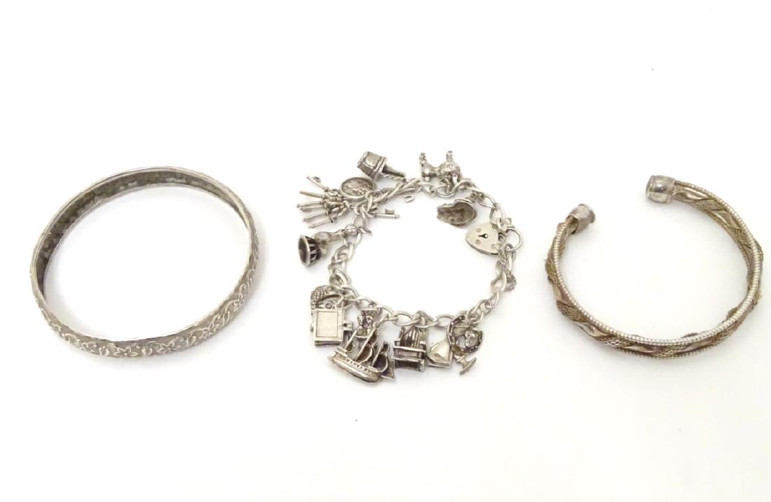 A silver charm bracelet set with 11 various silver and (1 of 6)