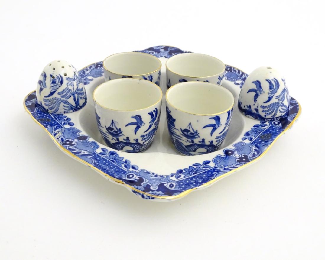 A blue and white Burleigh Ware egg cruet set to include: A blue and white Burleigh Ware egg cruet set to include four egg cups, a salt and pepper shaker contained within a dish, decorated with the 'Willow' pattern. Dish approx 7 1.4'' wide.