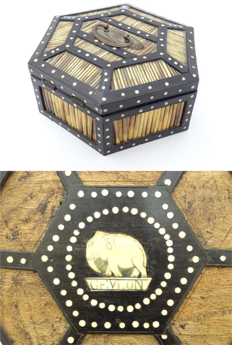 A Sri Lankan / Ceylon hexagonal quill work box with: A Sri Lankan / Ceylon hexagonal quill work box with ebony and bone detail and opening to reveal the underside of lid marked ' Ceylon' 9'' diameter