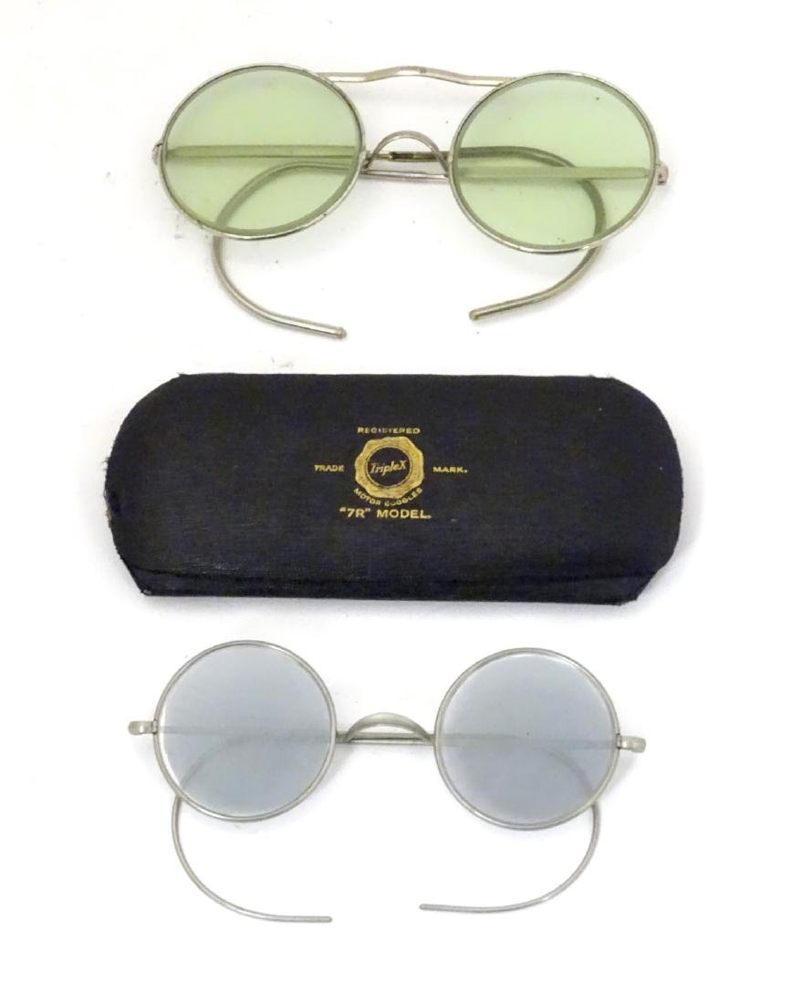 A pair of TripleX '7R' model tinted driving glasses: A pair of TripleX '7R' model tinted driving glasses together with another pair.