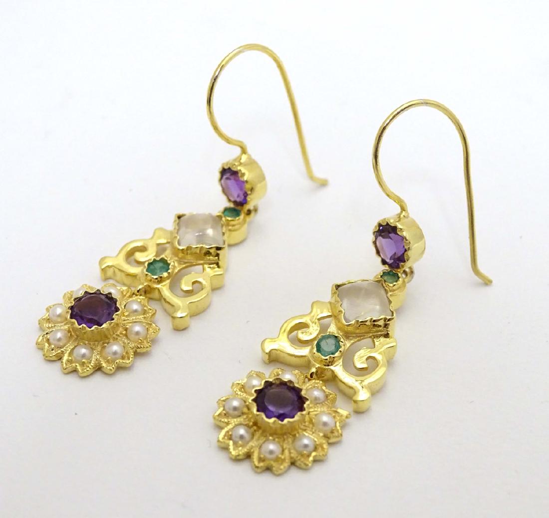 A pair of silver gilt drop earrings set with pearls,: A pair of silver gilt drop earrings set with pearls, moonstone, amethysts and peridot stones. 1 3/4'' long