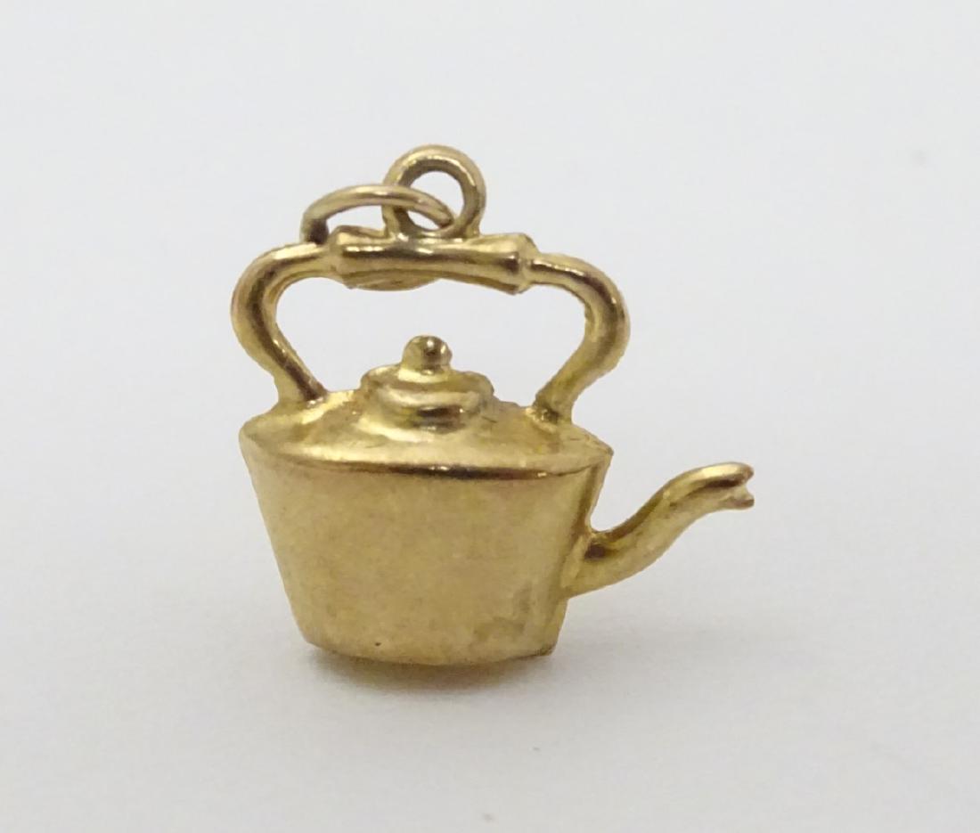 A Novelty pendant / charm formed as a kettle. Marked: A Novelty pendant / charm formed as a kettle. Marked 9ct 1/2'' high