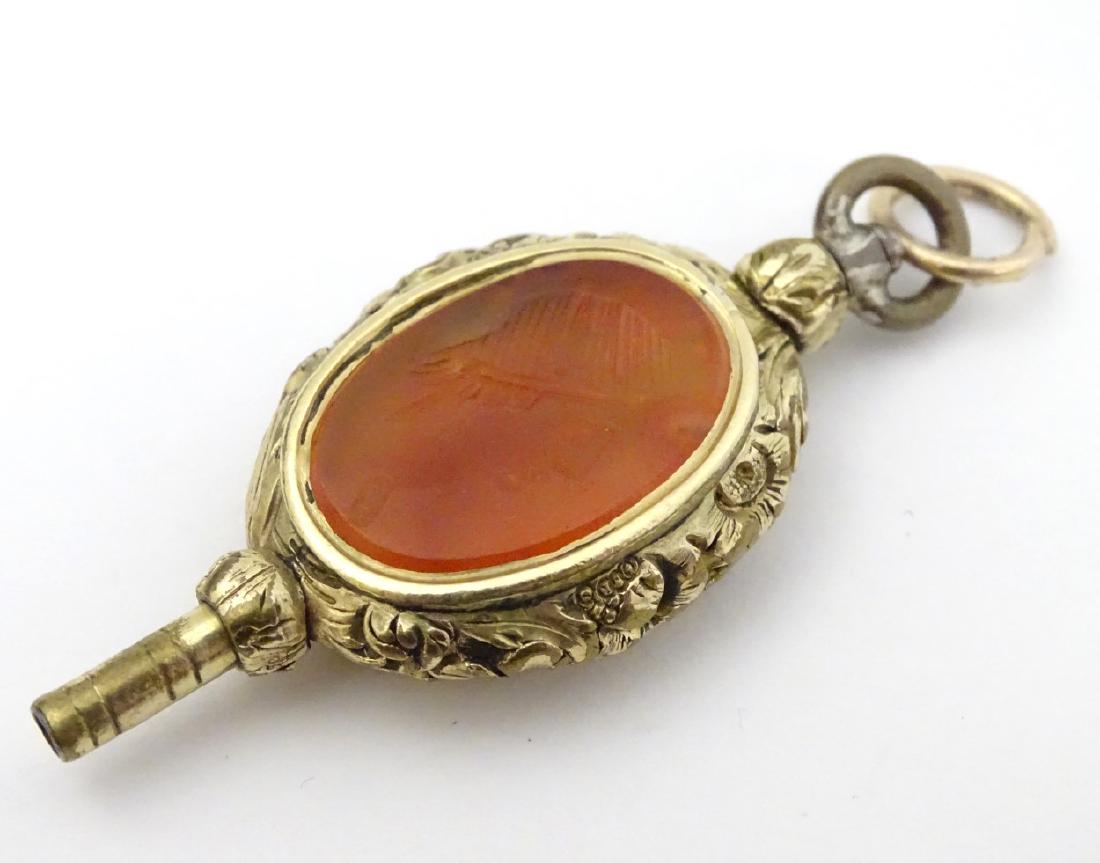 Victorian pocket watch key : a pendant gilt metal: Victorian pocket watch key : a pendant gilt metal intaglio carnelian pocket watch key with image of a bust head to one side, 1 7/8'' long