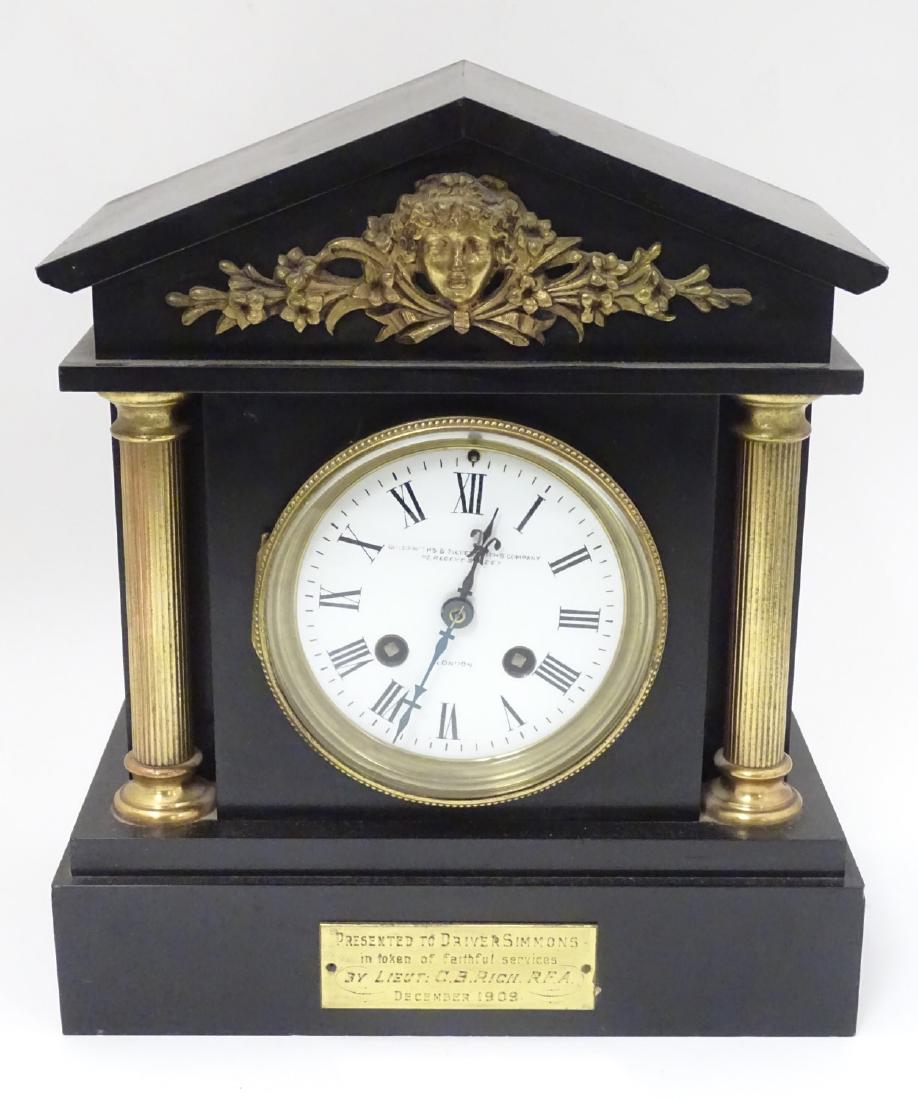 Goldsmiths and Silversmiths Co. 1909 Clock: An 8 day: Goldsmiths and Silversmiths Co. 1909 Clock: An 8 day Samuel Marti clock, the movement striking on a coiled gong on the hour and half hour, signed enamel 4 1/2'' dial the slate case with brass feeder c