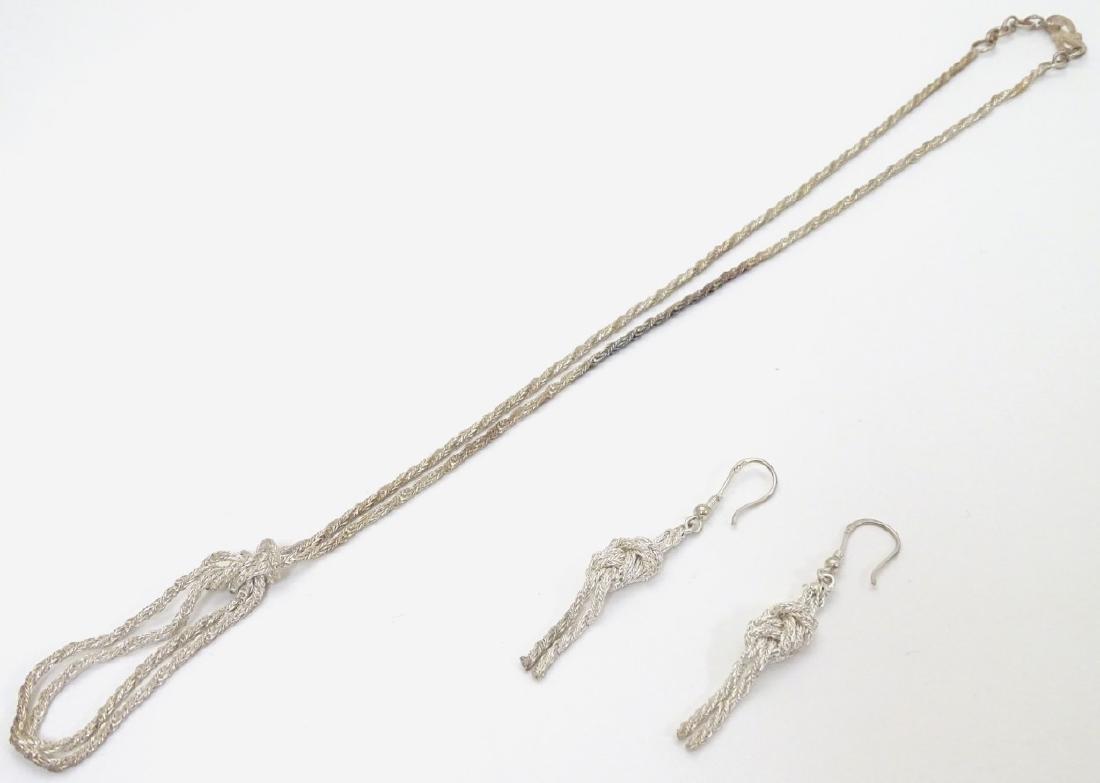 A silver necklace with rope twist and knot decoration: A silver necklace with rope twist and knot decoration approx 20'' long . Together with drop earrings the earrings approx 2 1/2'' long.