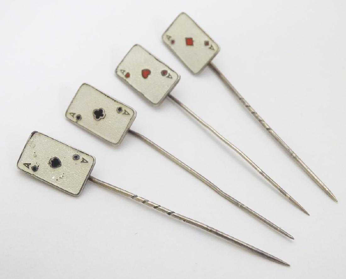 A set of 4 silver stick pins decorated with playing: A set of 4 silver stick pins decorated with playing card suite Aces to top with enamel decoration, possibly by Langston Silver works ( Bernard Instone) 2 3/4'' long